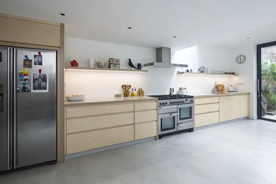 Modern plywood kitchen with a polished concrete floor.