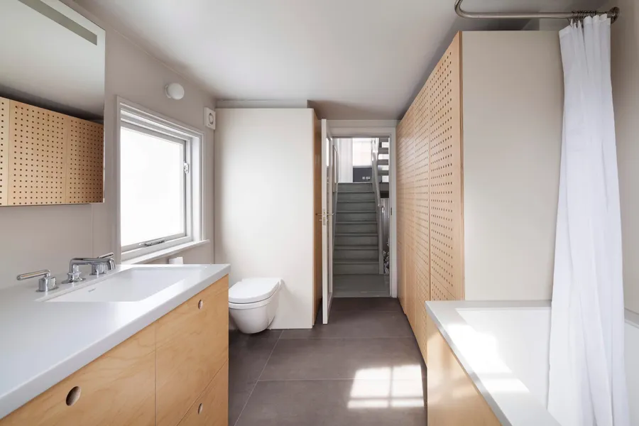Modern bathroom, CNC birch plywood, white Corian.