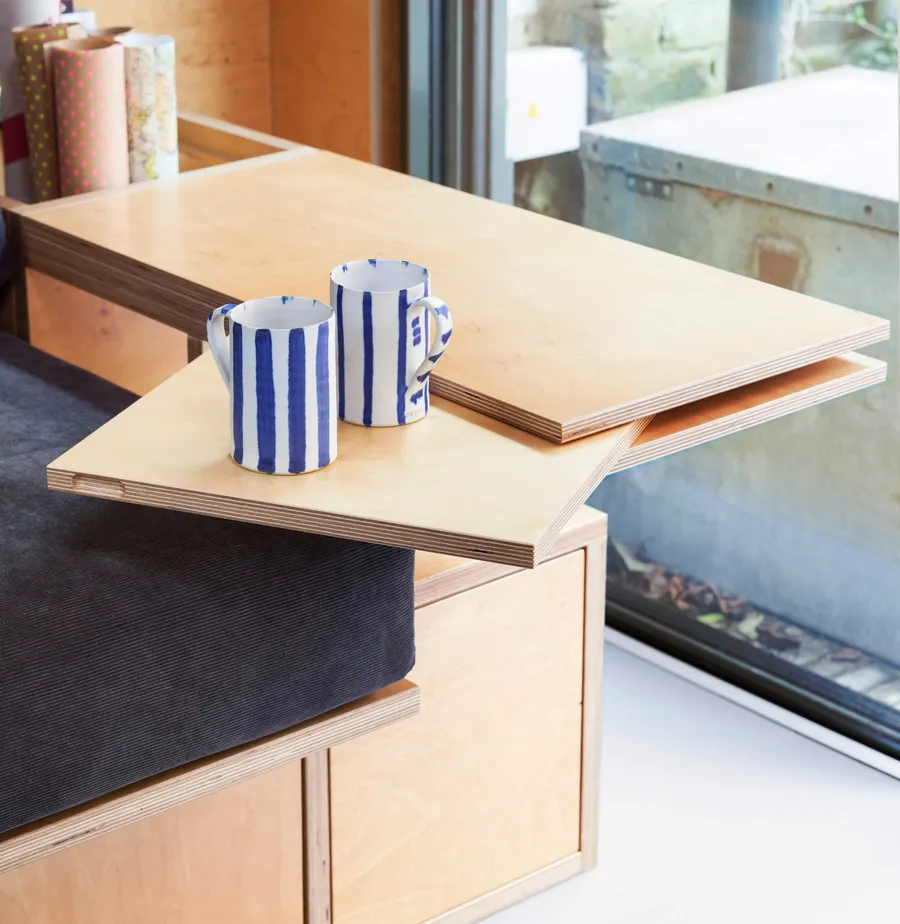 Birch plywood day bed with pivot sliding arm rest table.