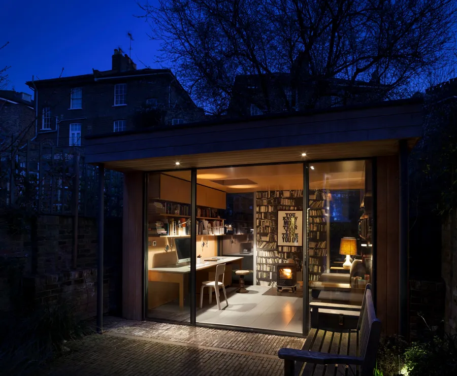 ​Modern garden office at night.
