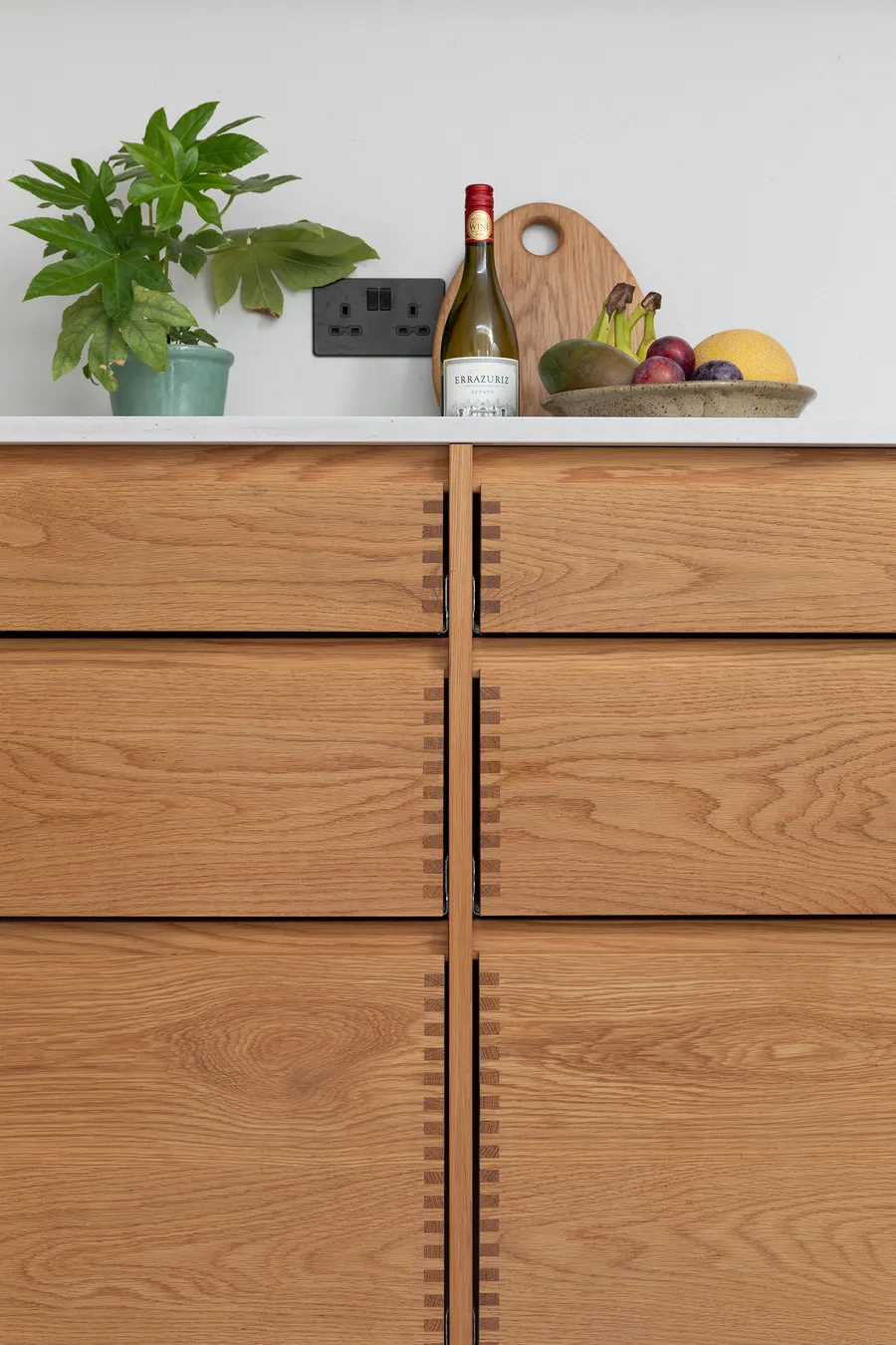 Close-up of the finger joints on the solid oak drawer fronts below the worktop.