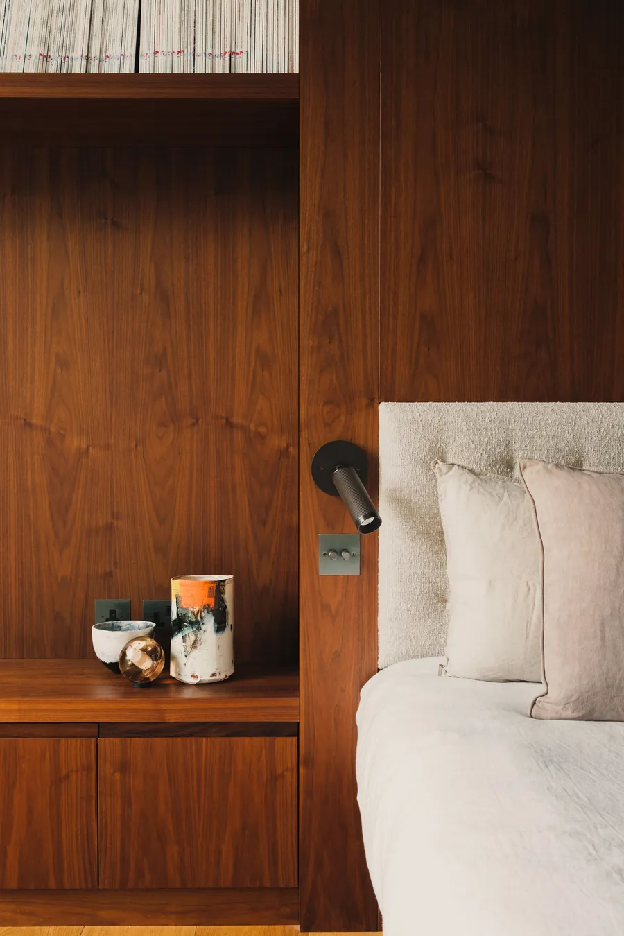 Walnut panelling, headboard and shelving.