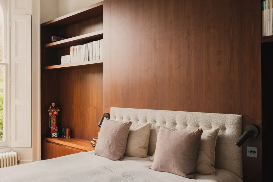 Walnut panelled headboard and shelving.