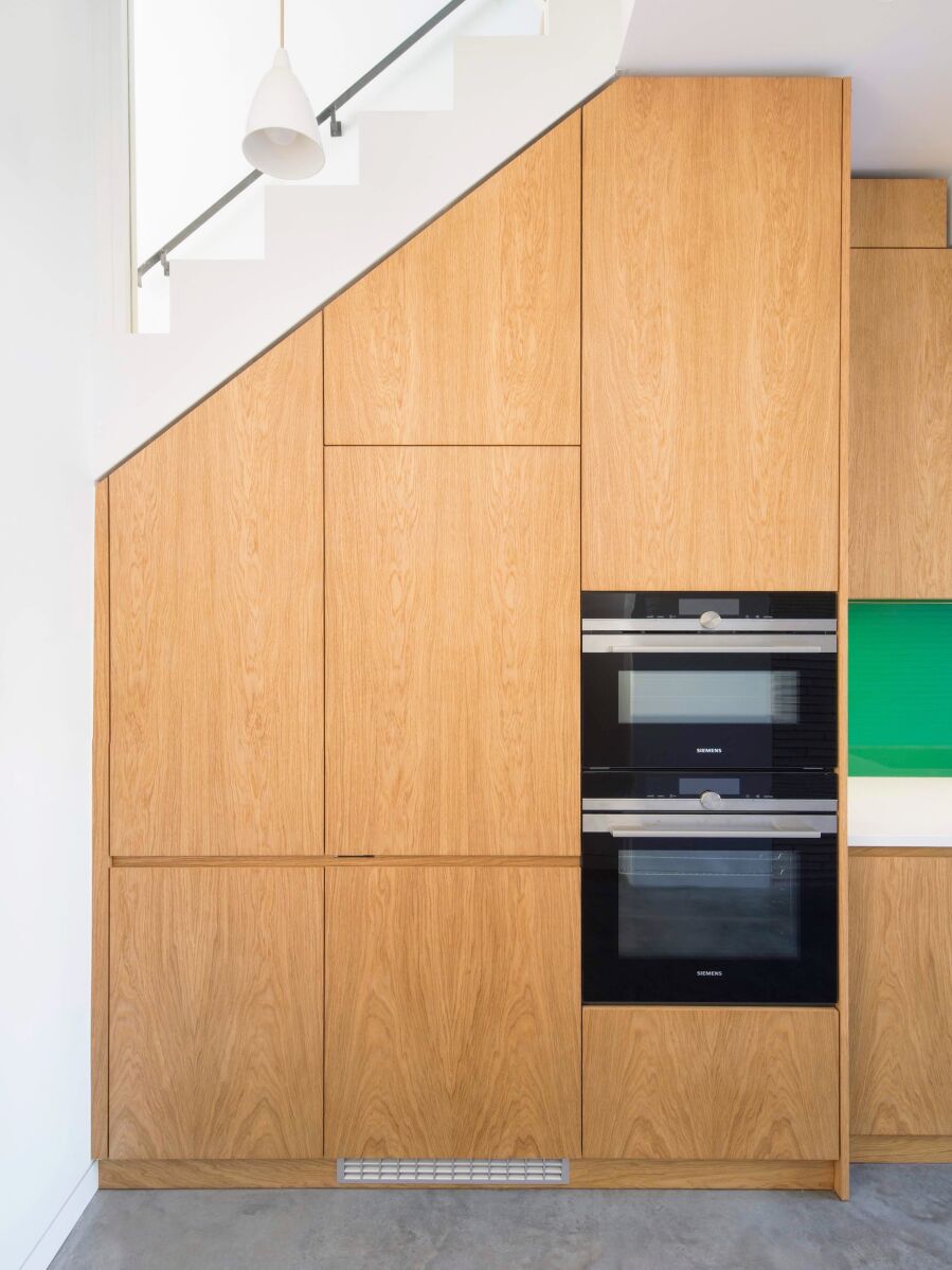 Oak kitchen fronts following the stairs..