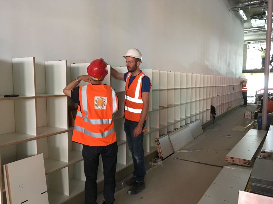 Onsite fitting of the Wall of Inspiration unit at Plexal.​.