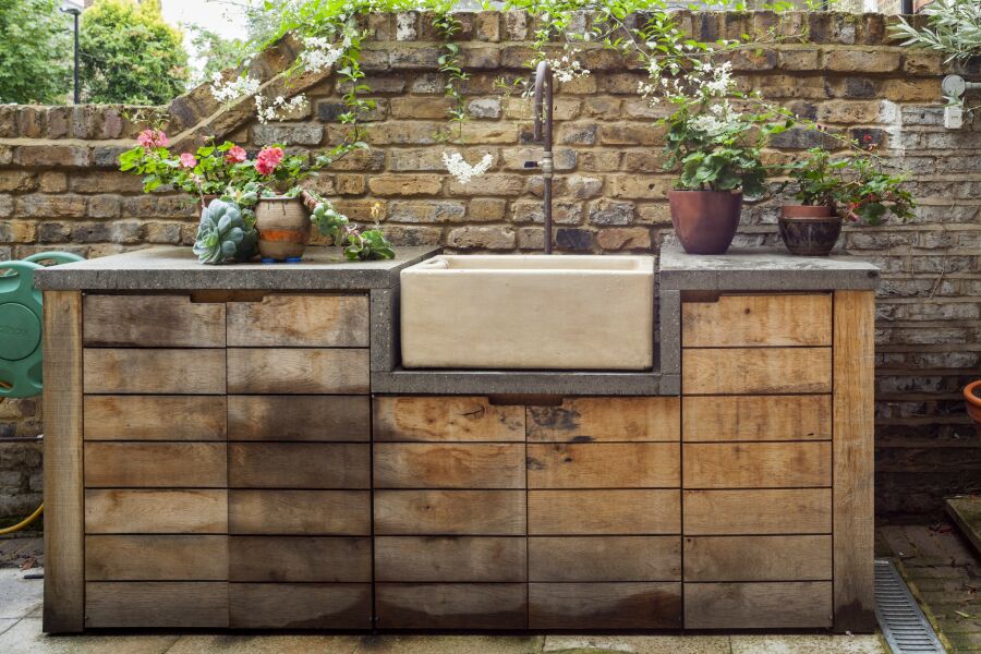 Exterior green oak unit, concrete worktop with butler sink and hand bent copper tap..