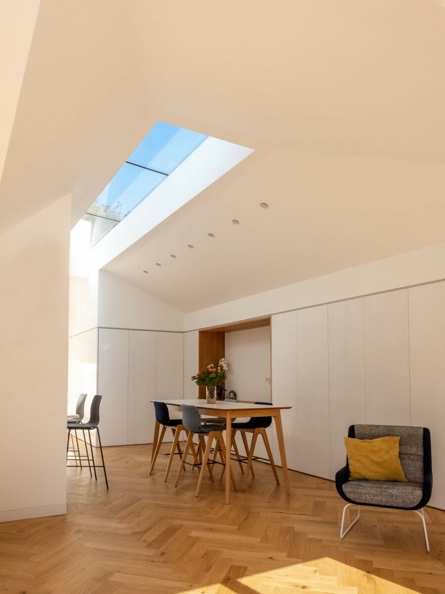 Modern dining room with hidden cabinetry flooded with natural light..