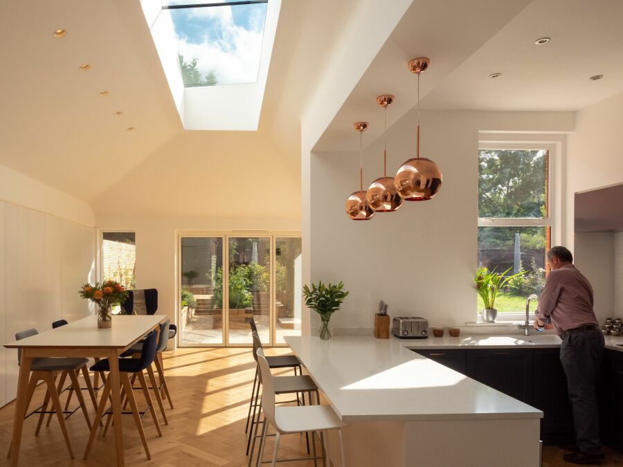 Modern kitchen and dining room flooded with natural light..