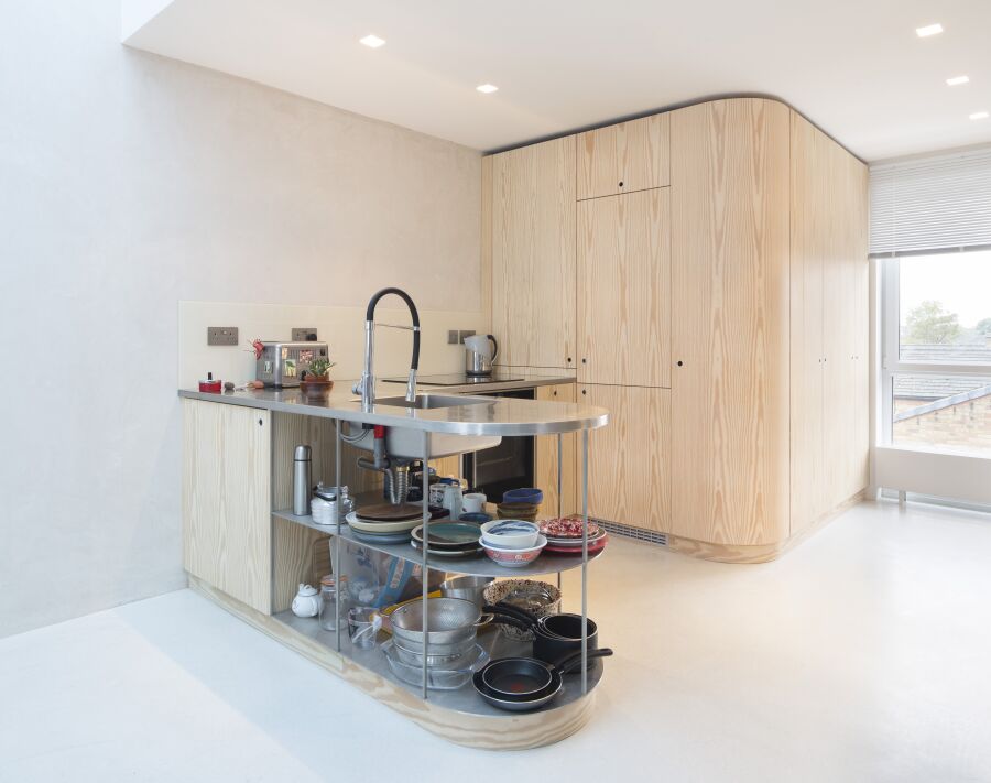 Curved Douglas Fir veneer kitchen​ with stainless steel counter-frame and worktops..