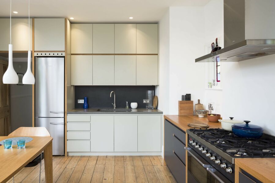 Modern kitchen with a mixture laminated plywood & sprayed fronts and concrete & solid oak worktops..