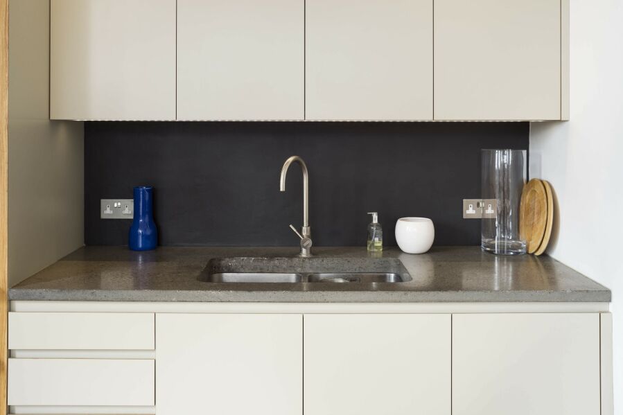 Modern kitchen with laminated plywood fronts and concrete worktop..