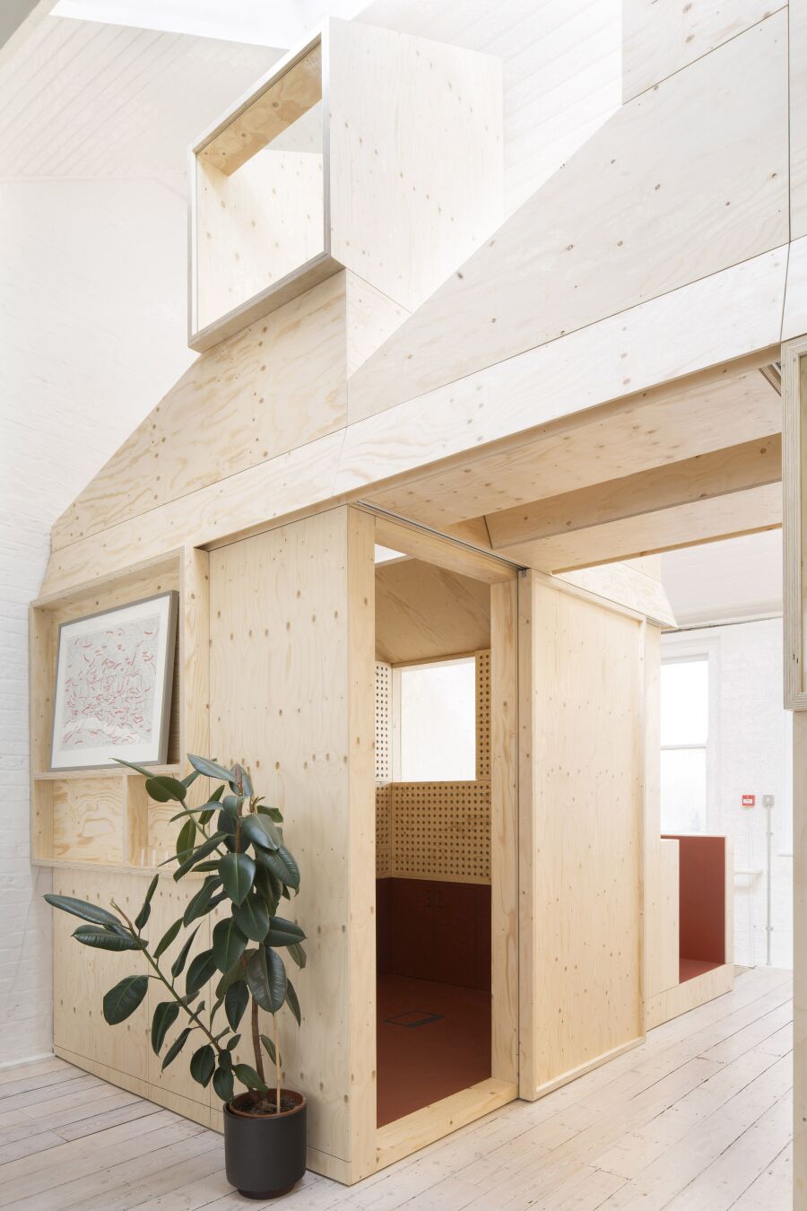 Spruce plywood office structure in a Victorian warehouse..