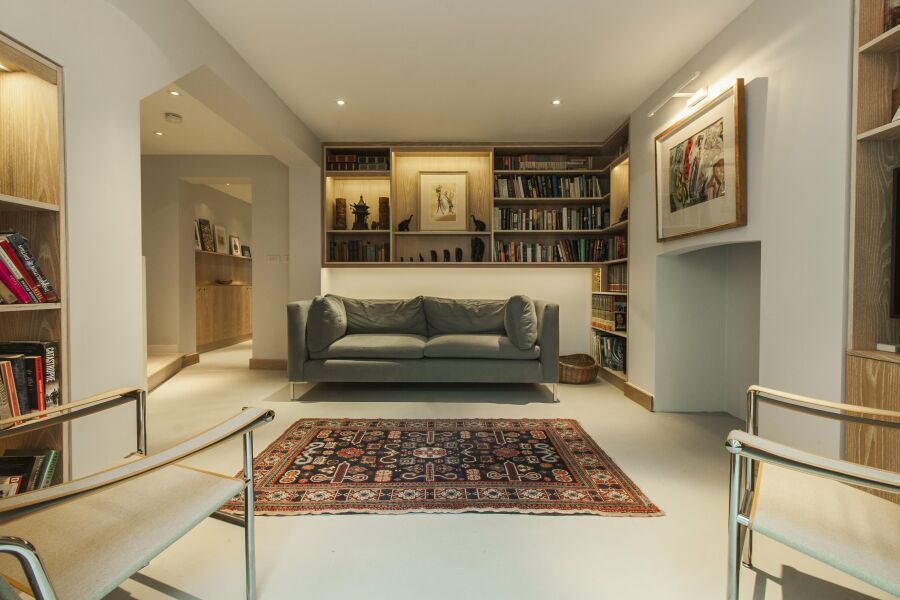 Limed oak veneered plywood floating library, alcoves and hallway shelving with LED lighting..