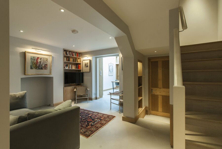 Lounge with limed oak veneered plywood alcove shelving..