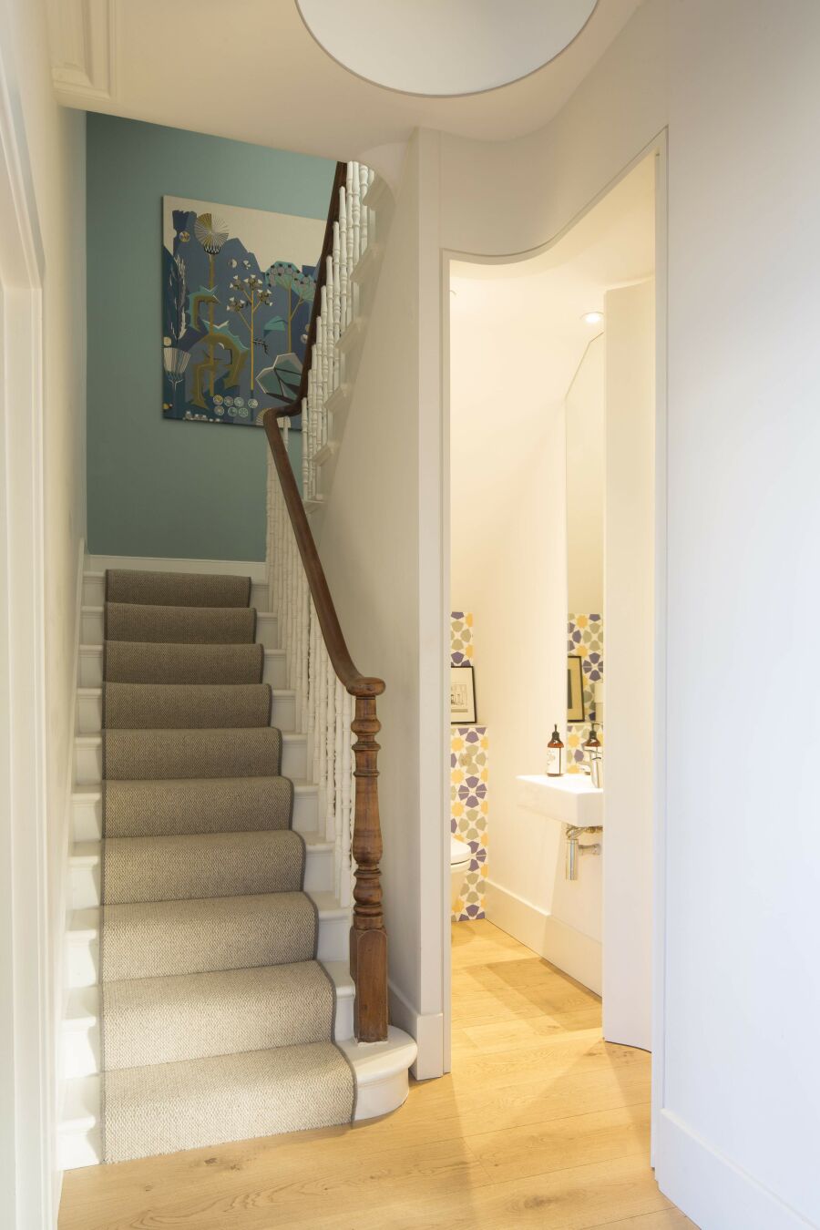 Hallway with curved bathroom full height door​.