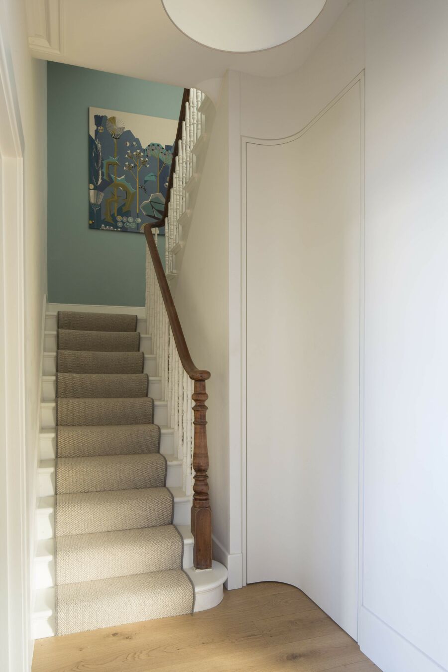 Hallway with curved bathroom full height door​.