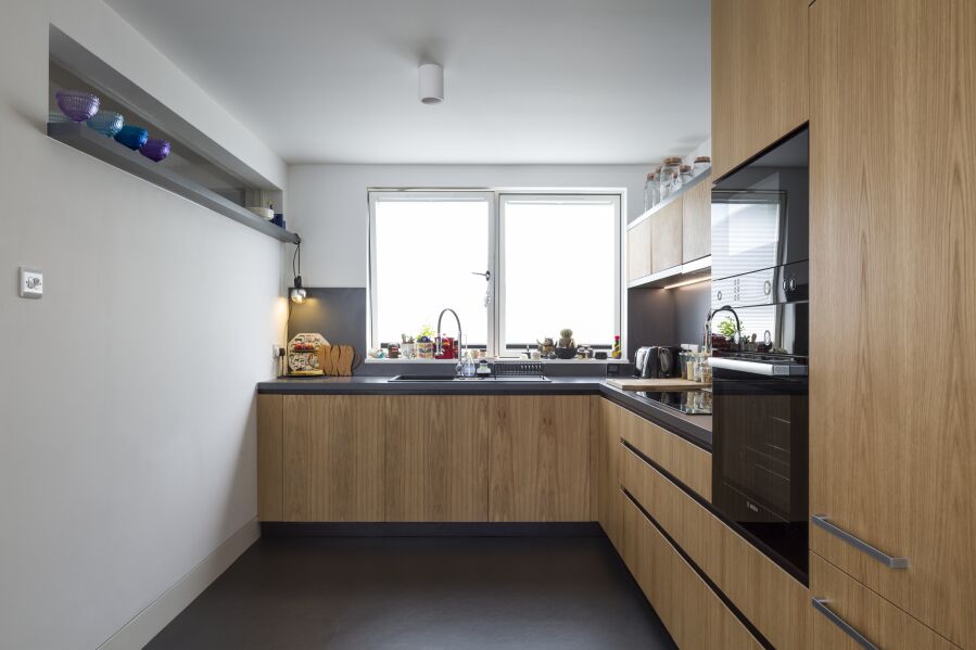 Kitchen with Oak veneered birch plywood fronts, Formica Colourcore worktops..