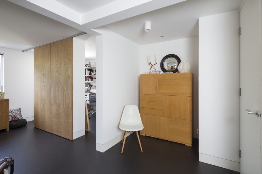 Oak veneered sliding doors to a hidden home office..