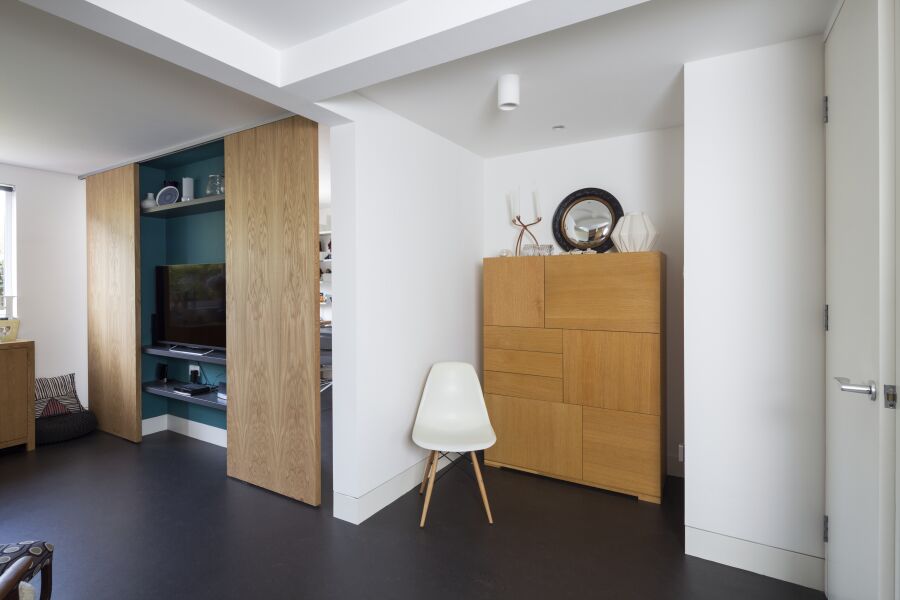 Oak veneered sliding doors to a hidden home office..