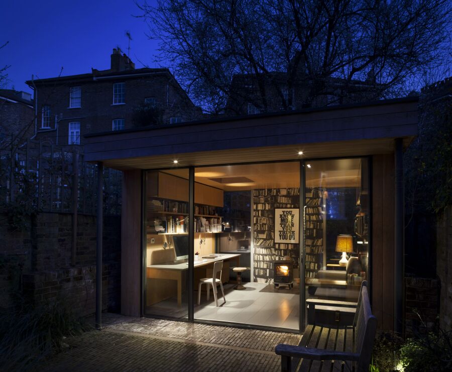 ​Modern garden office at night..