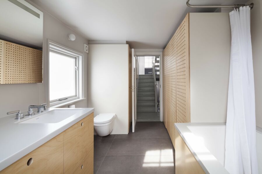 Modern bathroom, CNC birch plywood, white Corian.