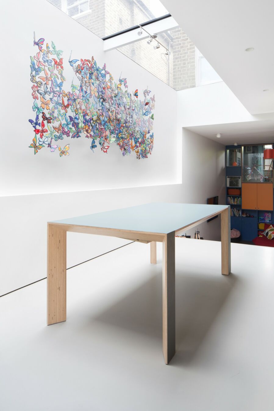 ​Sliding, extending, birch plywood extending table clad in Fenix..