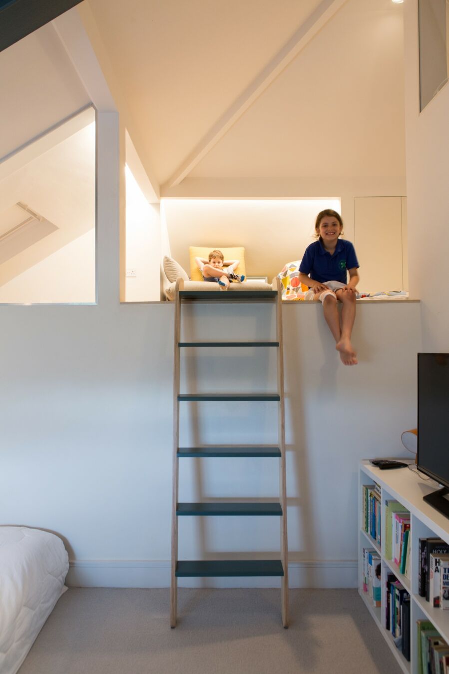 A removable, sliding loft ladder being put to good use..