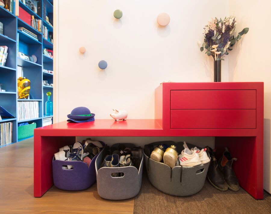 A deep pink, spray lacquered, entrance bench unit with drawers..