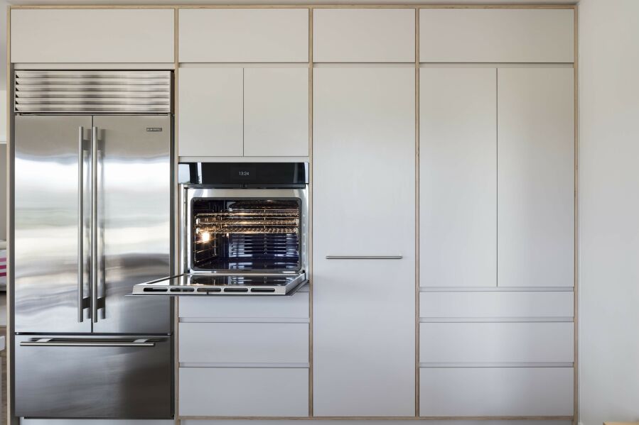 Modern kitchen with appliances, laminated birch plywood fronts and visible birch plywood edges..