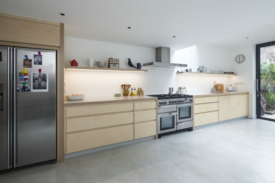 Modern plywood kitchen with a polished concrete floor.