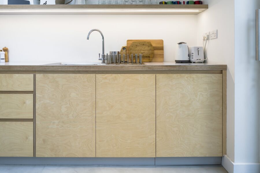 Plywood kitchen with exposed grain.
